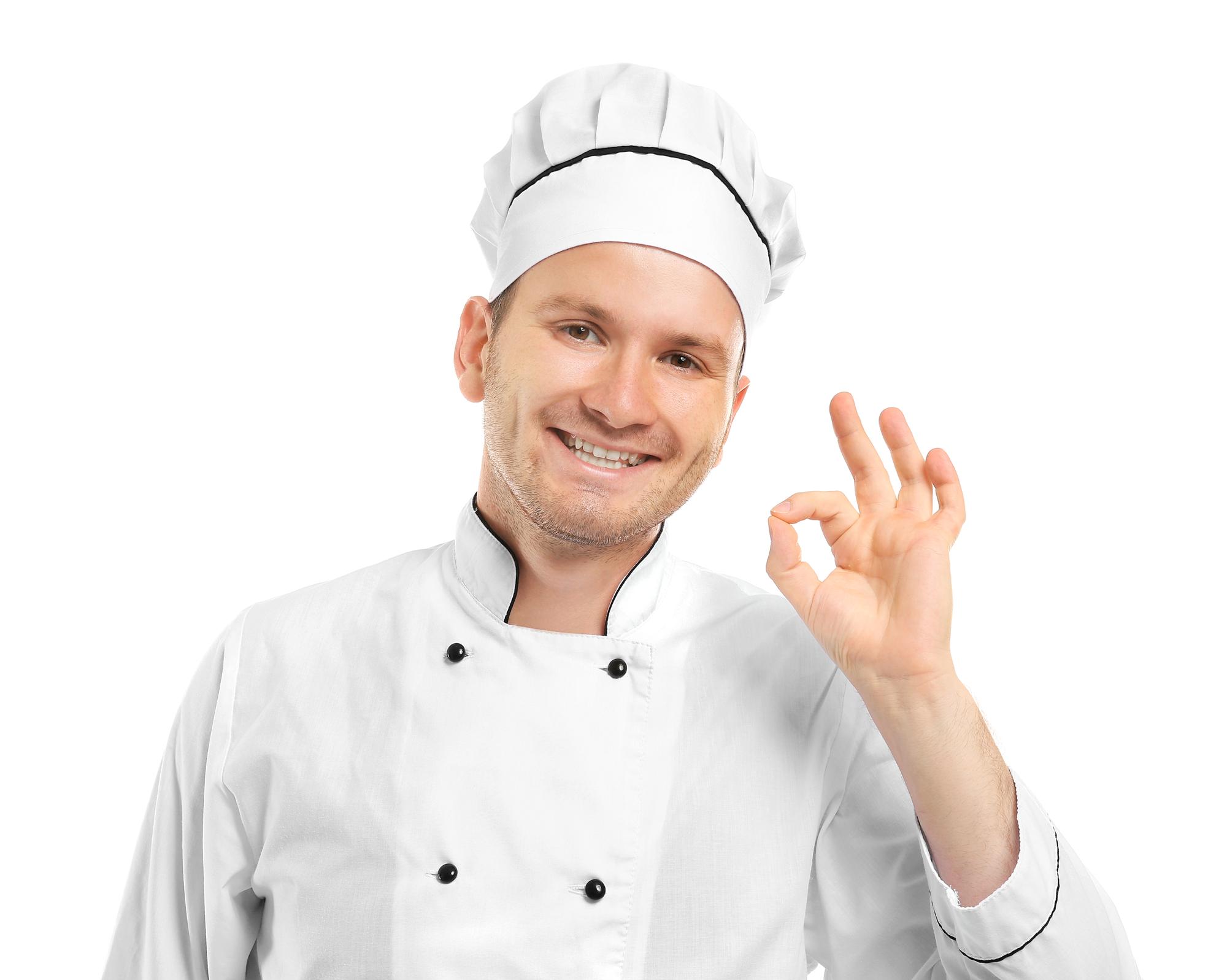Uśmiechnięty szef kuchni w pracowni kulinarnej